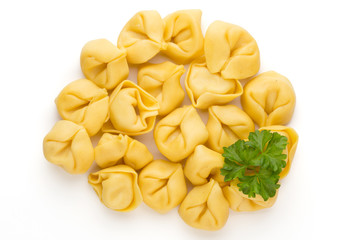 Raw homemade pasta,tortellini with herbs.