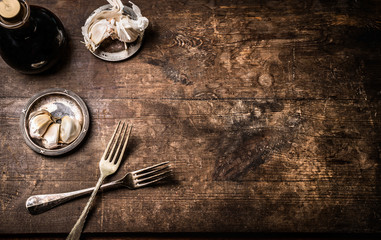 Dark rustic aged wooden food background with cutlery and seasoning, top view with copy space for your design,recipes,menu, meal or text