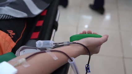 Health and Medical : Blood donor donation with bouncy ball holding in hand. Blood donation occurs when person voluntarily has blood drawn used for transfusions. Image for World blood donor day June 14