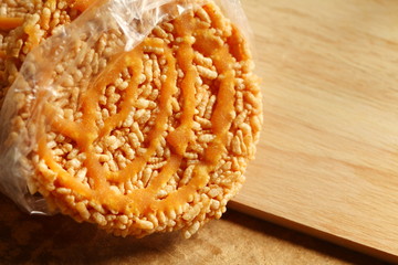 Round and flat sweetmeat in plastic bag scene represent thai dessert concept.