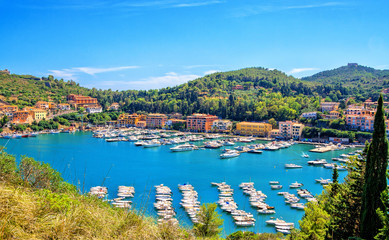 Fototapeta na wymiar Porto Ercole town, Monte Argentario, in the Province of Grosseto, Tuscany, Italy. Boats in harbor in a sea bay.