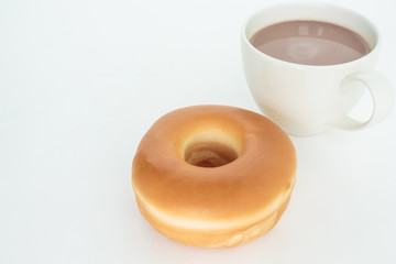 donut on white plate and cup cocoa drink top view on white background.