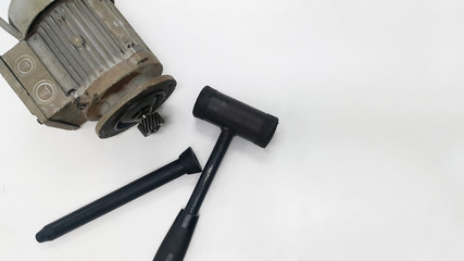 Electric motor with pinion gear and black hammer for Repair and Overhaul motor gear on white...