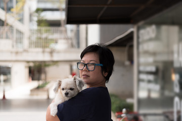 Asian woman hugging dog so cute at coffee shop
