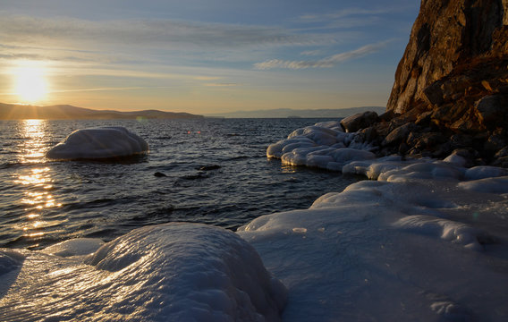 icy shore in the sunset and the sun 
