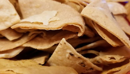 Close-up of totopos, hard tortilla or tortilla chips, typical traditional Mexican food to dip in salsa (sauce)