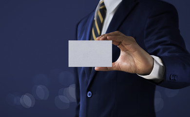 Business solution, strategy or success concept. Businessman is holding a paper card with blank...