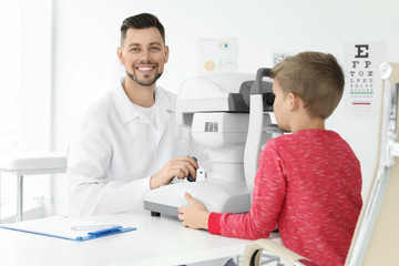 Fototapeta premium Ophthalmologist examining little boy in clinic