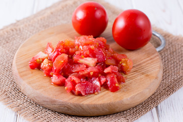 Red tomato slices on chopping board