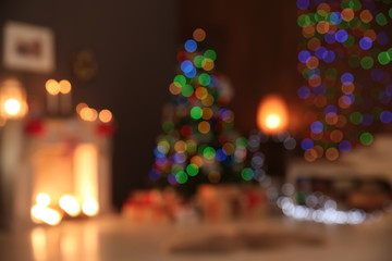 Blurred view of stylish living room interior with decorated Christmas tree at night