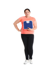 Fototapeta na wymiar Overweight woman in sportswear with scales on white background