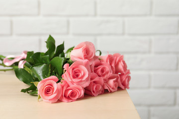 Bouquet of beautiful roses on table