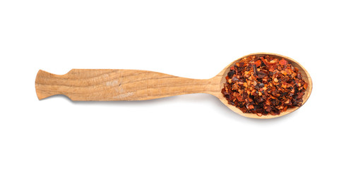 Wooden spoon with dried chopped chili pepper on white background. Different spices