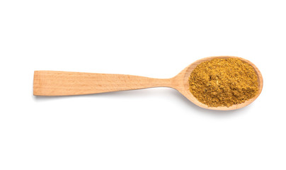 Wooden spoon with curry on white background. Different spices