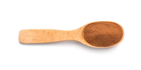 Wooden spoon with cinnamon powder on white background. Different spices