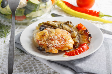 Traditional rustic stew of chicken and vegetables on plate with tomatoes, peppers