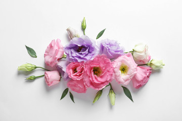 Flat lay composition with beautiful Eustoma flowers on light background