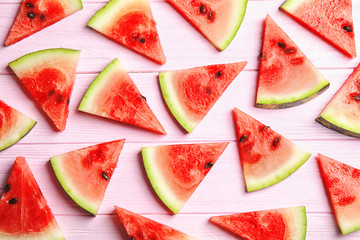 Flat lay composition with watermelon slices on wooden background