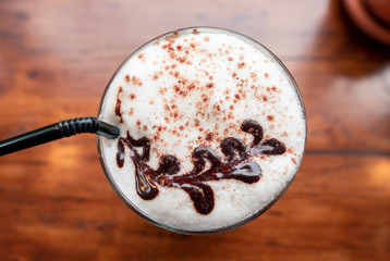 Chocolate paint Milk froth art on cocoa drink in the vintage cafe