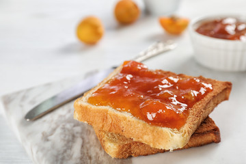 Bread with tasty apricot jam on board