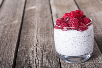 Chia pudding in glass with raspberry