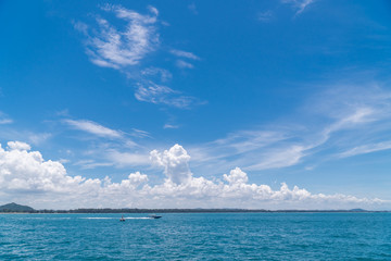 Naklejka na ściany i meble A boat on the sea with blue sky background. Maritime transport.