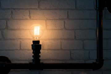 Fototapeta na wymiar Vintage glowing Light bulb on lamp stand