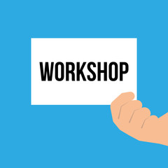 Man showing paper WORKSHOP text