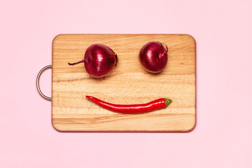Healthy Eating. Two Fresh Violet Bow Near Red Chilli Pepper On A Wooden Chopping Board
