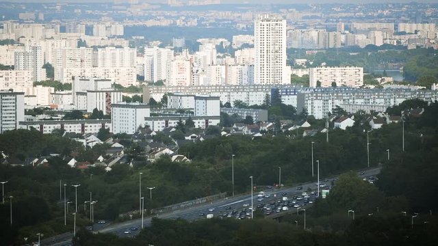 Heavy traffic jam over the A15 highway autoroute peripherique with the city of Sannois, Paris in the background - aerial still drone news report