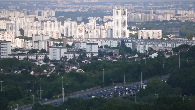Aerial news report using drone with heavy traffic jam over the A15 highway autoroute peripherique with the city of Sannois, Paris in the background