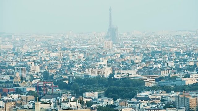 Blue cold colors of cinematic aerial of Eiffel Tower - Tour Eiffel in Paris, France with sparkling glittering light illumination turned on during the day