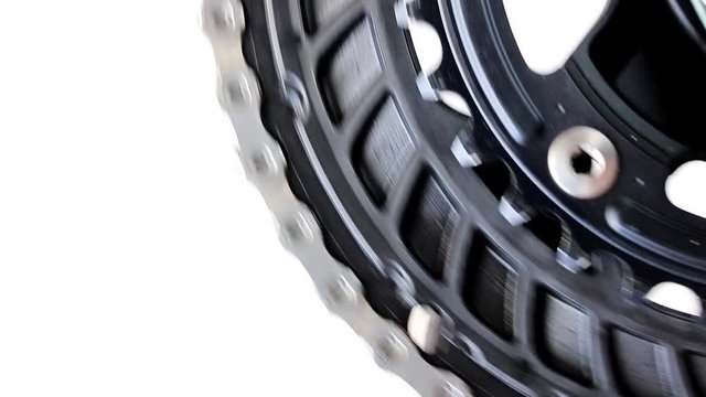 The drive gear with pedal of bicycle is rotated on a white background. Chain to drive gear wheel to bike, close-up view.