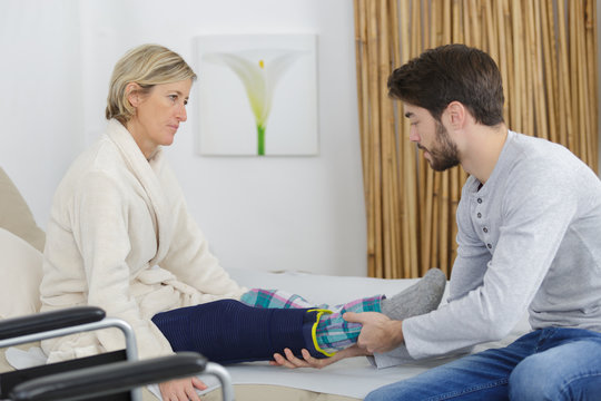 physiotherapist caring lady leg in medical room