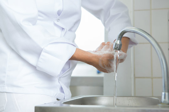 chef washing hand under running water