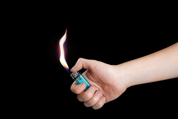 Hand burning a lighter on black background - obrazy, fototapety, plakaty