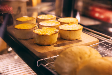 Cheese tarts on wooden plate that ready for sell.