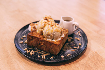 Honey toast with ice cream topping with caramel and almond.