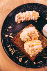 Top view of Honey toast with ice cream topping with caramel and almond.