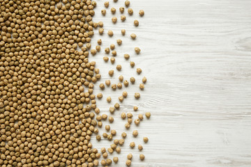 Dried chickpeas on white background, top view. Copy space.