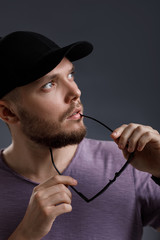 young bearded man in cap and sunglasses