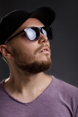 Obraz premium young bearded man in cap and sunglasses