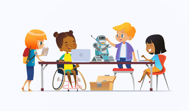 Disabled African American girl in wheelchair and other children standing around desk with laptops and robot and working on school project for programming lesson. Concept of inclusion at school.