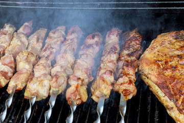 Marinated shashlik preparing on a barbecue grill over charcoal. Shashlik or Shish kebab