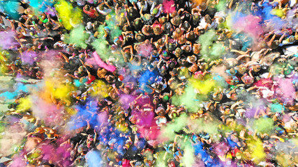 Aerial top view of a Holi Colors Festival. Splash of paint in a crowd of people view above.