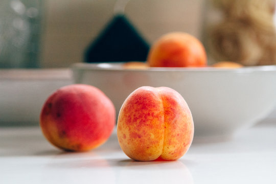 Fresh peaches on the white kitchen table. Local market products. Filtered image