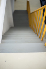 Wooden staircase with yellow railing