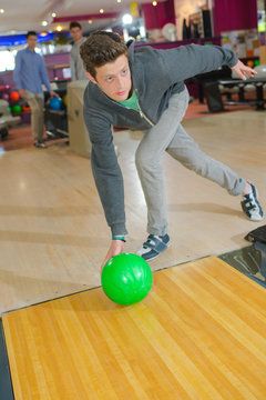 man striking a bowling ball