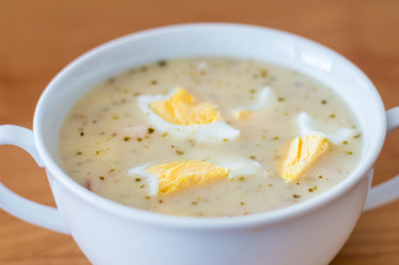 Polish soup zurek with eggs on the top.