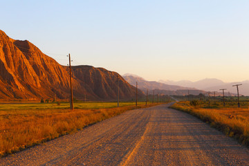 Mountain dirt road. Sunset. Kyrgyzstan